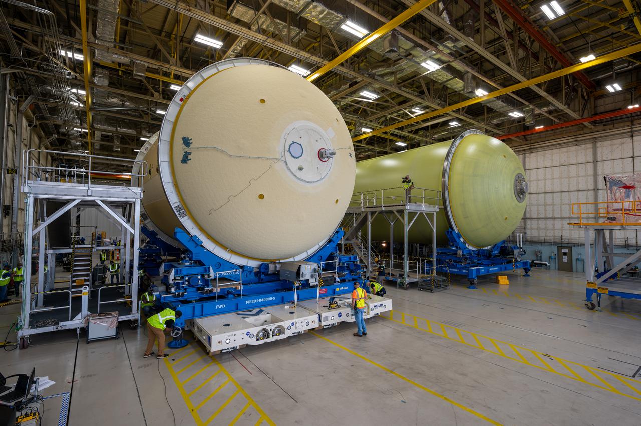 This image shows technicians and engineers moving the liquid oxygen tank (LOX) into position as they continue the process of the forward join on the core stage of NASA’s Space Launch System rocket for Artemis II, the first crewed mission of NASA’s Artemis program at NASA’s Michoud Assembly Facility. The forward join connects the forward skirt, the liquid oxygen tank (LOX) and the intertank structures to form the top part of the SLS rocket’s core stage. Now, NASA and Boeing, the SLS prime contractor, will continue to integrate various systems inside the forward part of the core stage and prepare for structural joining of the liquid hydrogen tank and engine section to form the bottom of the stage.  Together with its four RS-25 engines, the rocket’s massive 212-foot-tall core stage — the largest stage NASA has ever built — and its twin solid rocket boosters will produce 8.8 million pounds of thrust to send NASA’s Orion spacecraft, astronauts and supplies beyond Earth’s orbit to the Moon and, ultimately, Mars. Offering more payload mass, volume capability and energy to speed missions through space, the SLS rocket, along with NASA’s Gateway in lunar orbit, the Human Landing System, and Orion spacecraft, is part of NASA’s backbone for deep space exploration and the Artemis lunar program. No other rocket is capable of carrying astronauts in Orion around the Moon in a single mission. Image credit: NASA/Jared Lyons
